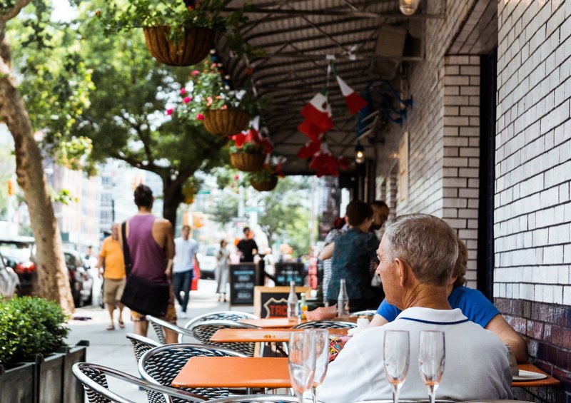 Man sitting outside cafe in the summer 