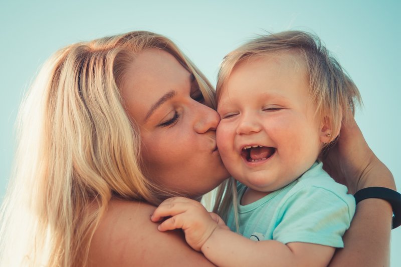 Woman smoking near mum and child